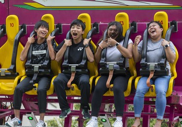 L to R Tsubasa Hagiwara and Kentarou Ohno of Tokyo, Japan have a screaming good time on the Full Tilt ride with London sisters Princess and Nichole Navalta at The London Rib Fest and Craft Beer Festival in Victoria Park in London, Ont. on Monday August 5, 2019.  They enjoyed the thrill ride so much, they got right back on for a second spin. Derek Ruttan/The London Free Press/Postmedia Network