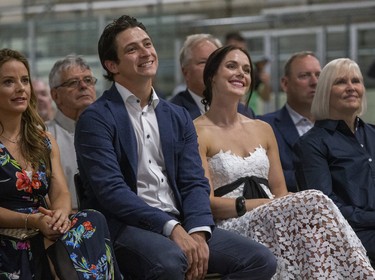 Scott Moir and Tessa Virtue listen to reminiscences by their coaches Marie-France Dubreuil and Patrice Lauzon before taking the stage themselves to unveil Moir's Canada Walk of Fame Plaque at the Ilderton Arena in Ilderton, Ont. on Wednesday August 7, 2019. Derek Ruttan/The London Free Press/Postmedia Network