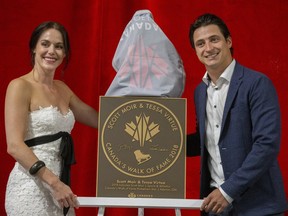 Scott Moir and Tessa Virtue unveil Moir's Canada Walk of Fame plaque at the Ilderton Arena in Ilderton on Wednesday. (Derek Ruttan/The London Free Press)
