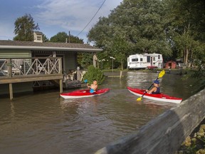 The Carlsen brothers, Keller (11) (left) and Riker (9) of Chatham  kayak over the front lawns of neighbours of their grandfather Randy Morton in Erieau, Ont. on Tuesday August 27, 2019. The boys were staying with their grandfather at his trailer when Lake Erie spilled it's banks and flooded several homes on the shoreline. Morton's trailer is on higher ground and was untouched by the water. Derek Ruttan/The London Free Press/Postmedia Network