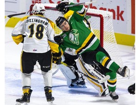 Sarnia Sting goalie Cameron Lamour gets away with a slew-foot on London Knight Billy Moskal during a game in London. (Derek Ruttan/The London Free Press)