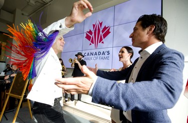 Arkells frontman Max Kerman crosses the stage to embrace Scott Moir and Tessa Virtue as the Arkells crashed the Canada's Walk of Fame ceremony honouring Tessa Virtue at Museum London on Wednesday August 7, 2019.  Mike Hensen/The London Free Press/Postmedia Network