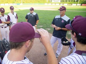 Head coach Mike Lumley of the London Badgers huddles with his team before a recent game against the St. Thomas Tomcats at Labatt Park. (Mike Hensen/The London Free Press)