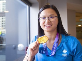 Maggie Mac Neil of London shows off her gold medal she won in the recent World Championships in Gangju South Korea in July.   (Mike Hensen/The London Free Press)