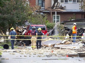 Fire officials survey the damage at 450 Woodman Ave. in London's Old East neighbourhood after a car drove into it, triggering an explosion. Photograph taken on Thursday August 15, 2019.  Mike Hensen/The London Free Press