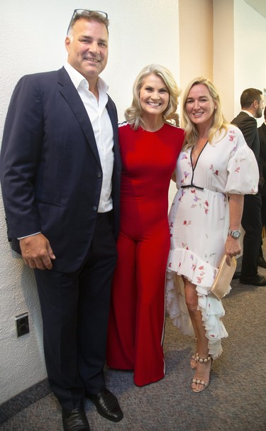 Eric and Kina Lindros embrace Christine Simpson at Logan Couture's All-In for Brain Research charity event at Centennial Hall in London, Ont.  Mike Hensen/The London Free Press/Postmedia Network