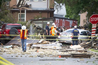 London fire inspectors and the Ontario Fire Marshall survey the scene at 450 Woodman after a car being driven the wrong way of Queens Ave crashed into a home at 450 Woodman Avenue and caused a huge natural gas leak leading to a massive explosion that demolished the house as well as severely damaged several others in the old east village in London, Ont.  Photograph taken on Thursday August 15, 2019.  Mike Hensen/The London Free Press/Postmedia Network