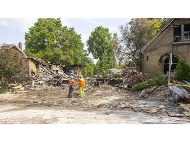Workers at the site of the natural gas explosion that totally demolished the house at 450 Woodman and almost destroyed the two neighbouring homes in London, Ont.  Photograph taken on Friday August 16, 2019.  Mike Hensen/The London Free Press/Postmedia Network