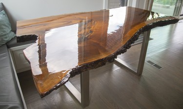 The live-edge black walnut dining table was custom built from a tree on the former Donnelly farm near Lucan. (Mike Hensen/The London Free Press)