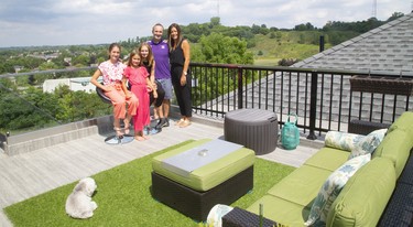 The Martins enjoy a spectacular view reaching to Masonville from their rooftop patio. From left, are daughters Tienna, Sofia and Bella with dad, Glen and mom, Denise. (Mike Hensen/The London Free Press)