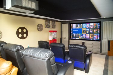 The entertainment room features a large Runco projector for perfect picture reproduction as well as comfortable seating. (Mike Hensen/The London Free Press)