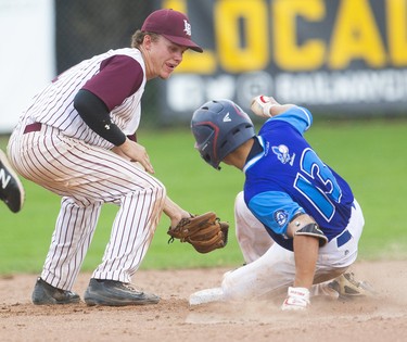 Daniel Boldt of the Badgers waits at second but Quebec's Ian-Michel Lavigne beats the throw from centre field for a double during their semi-final game.  Lavingne's 4th inning shot started a 5 run inning for the Quebec team that ended up winning 6-1Sunday morning in Labatt Park in the semi-final of the Canadian National U18 tournament in London, Ont.   Mike Hensen/The London Free Press/Postmedia Network