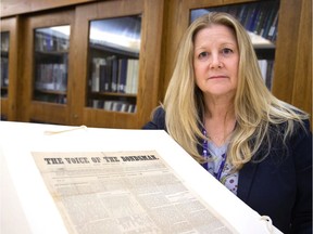 Debbie Meert-Williston, a special collections and rare books librarian at Western University's Weldon Library, shows a portion of a rare abolitionist newspaper printed in Stratford in the mid 1800s that was recently found folded in a book in their special collections.  (Mike Hensen/The London Free Press)
