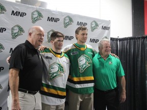 Left to right: London Knights general manager Mark Hunter, players Connor McMichael and Alex Regula, and head coach Dale Hunter pose with the Knights' new jersey for the 2019-20 season. (Sebastian Bron/The London Free Press)