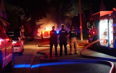 London firefighters battle a major fire on Woodman Aveune and Queens Avenue in Old East Village after a car slammed into a house. (MAX MARTIN, The London Free Press)