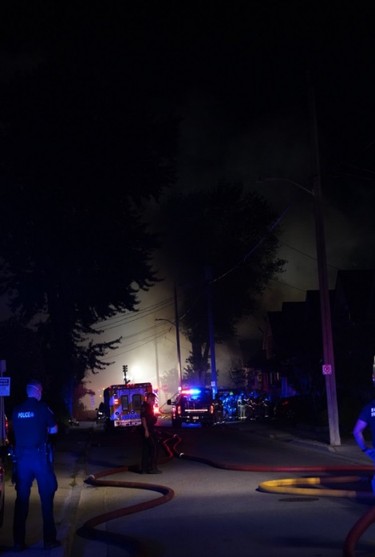 London firefighters battle a major fire on Woodman Aveune and Queens Avenue in Old East Village after a car slammed into a house. (MAX MARTIN, The London Free Press)