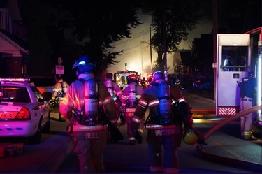 London firefighters battle a major fire on Woodman and Queens avenues in Old East Village after a car slammed into a house. (MAX MARTIN, The London Free Press)