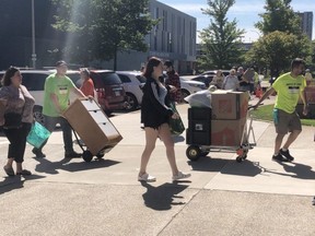 Parents and new Fanshawe College students move boxes and bags into the Peregrine House residence on move-in day Saturday Aug. 31, 2019.