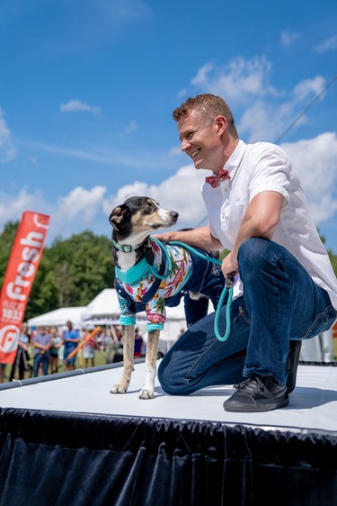 Kevin Kooger poses with Fargo, a two-year-old hound mix and ARF rescue dog, at Pawlooza's dog fashion show.