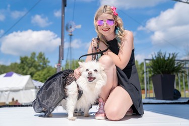 Kelsey-Rose MacDonald helped the dog models down the runway at Pawlooza's fashion show. The outfits were created by Ruff Stitched.
