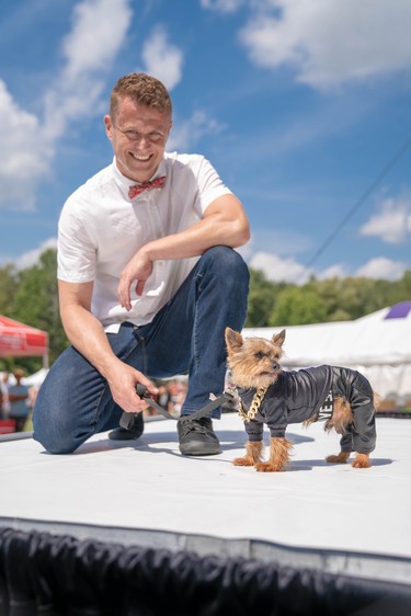 Kevin Kooger takes to the stage with Fez, a 13-year-old Yorkie mix at Pawlooza's dog fashion show.