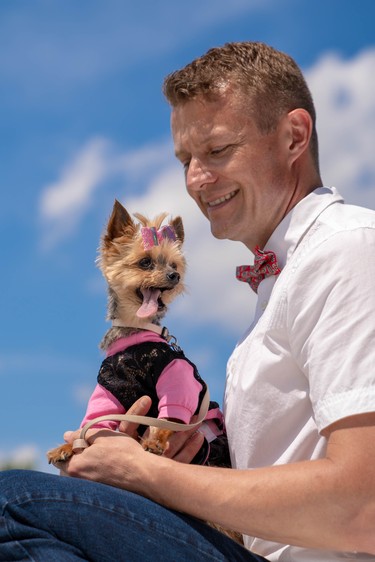 Kevin Kooger takes to the stage with Daisy, a Yorkie, at Pawlooza's dog fashion show.