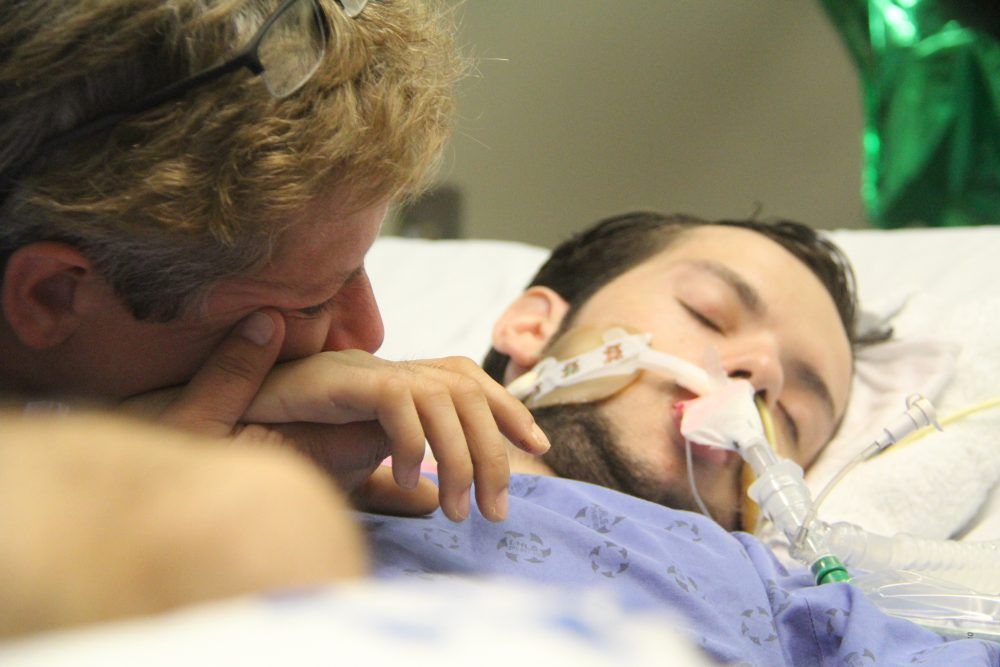  Abby Roby, left, is shown in hospital at the bedside of her son Tristan Roby, who was badly hurt in a hit-and-run while cycling along Exeter Road. Photo taken on Aug. 30, 2019. (Free Press file photo)