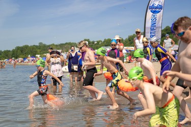 Participants in the Canadian Freshwater Alliance's learn to swim event in Port Stanley race into the water.