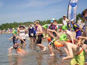 Participants in the Canadian Freshwater Alliance's learn to swim event in Port Stanley race into the water.
