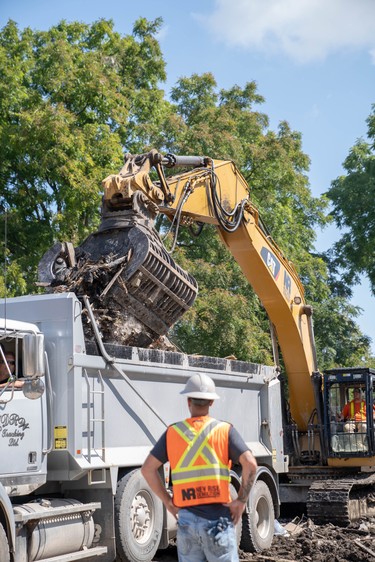 Crews continue to clean up the destruction on Woodman Avenue Saturday morning. Three homes on the street have been demolished.