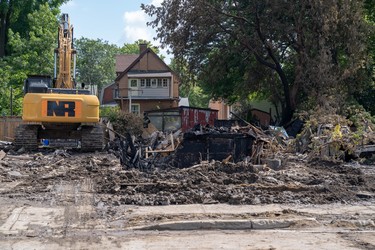 Crews continue to clean up the destruction on Woodman Avenue Saturday morning. Three homes on the street have been demolished.