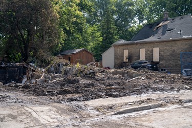 Crews continue to clean up the destruction on Woodman Avenue Saturday morning. Three homes on the street have been demolished.