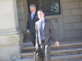 St. Thomas police officer Garry Christiansen, left, and his lawyer Lucas O’Hara, leave the Elgin County Courthouse Tuesday after Christiansen pleaded guilty to sexual interference with a girl under the age of 16. (LAURA BROADLEY, Times-Journal)