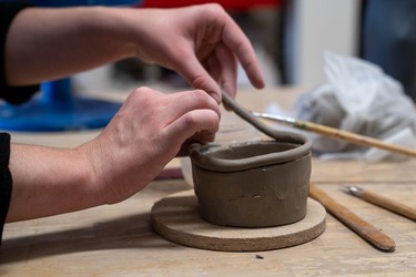 Jaxx Bonnamie works on a piece at the London Clay Art Centre. (MAX MARTIN, The London Free Press)