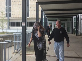 Karen Edel-Savage, 59, covers her face to avoid reporter after leaving her sentencing hearing in Sarnia. She pleaded guilty to criminal negligence causing death in the overdose death of Daniel Lapointe, 38, on Aug. 9, 2017. She had sold him cocaine laced with fentanyl. She will be sentenced next week. (JANE SIMS, The London Free Press)