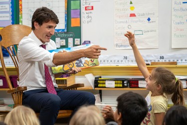 Prime Minister Justin Trudeau reads Why I Love Canada to pupils at Blessed Sacrament Catholic elementary school Monday. Elona Ibraheem, 7, eagerly tried to get his attention to answer a question. The Liberal leader was in London as part of the campaign trail. (MAX MARTIN, The London Free Press)