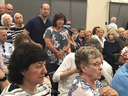 Barb Dorrington, at the mic, asks local candidates their views on palliative care during a panel discussion at the Kiwanis seniors’ community centre Thursday. (HEATHER RIVERS, The London Free Press) 