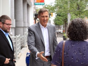 PPC Leader Maxime Bernier, centre, speaks with local PPC candidates Darryl Burrell, left, and Cathy Burr, spouse of candidate Dan Burr (not shown) during visit to Windsor Star at 300 Ouellette Ave. Monday. (NICK BRANCACCIO/Windsor Star)