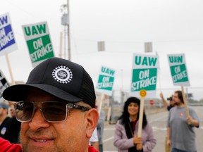 David Garcia, a United Auto Workers (UAW) member who is employed at the General Motors Co. Flint Assembly plant in Flint, Michigan, pickets outside of the plant as they strike on September 16, 2019. (Photo by JEFF KOWALSKY / AFP)