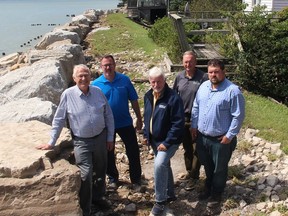 Ontario Agriculture Minister Ernie Hardeman, left, was joined by Chatham-Kent Mayor Darrin Canniff, second left, Chatham-Kent Leamington MPP Rick Nicholls, middle, Thomas Kelly, general manager of infrastructure and engineering for Chatham-Kent and South Kent Coun. Anthony Ceccacci, right, while touring the Erieau area on Saturday to assess flood damage caused by recent storm.