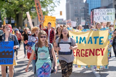 Karissa Vizniowski, 13, marches with hundreds of other students as part of the Global Climate Strike. The group marched down Dufferin Street, up Richmond Street, across Oxford Street before returning to city hall. (Max Martin, The London Free Press)