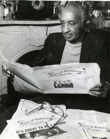 James F. Jenkins, owner and publisher of Canada's only newspaper for blacks, The Dawn of Tomorrow, looks over some back issues. The newspaper was started by his parents in 1921. (London Free Press files, 1990)