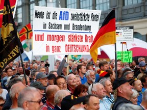 Supporters of the anti-Islam movement PEGIDA (Patriotic Europeans Against the Islamisation of the West) gather following the federal state elections of Saxony during a demonstration at the main railway station of Dresden, Germany, September 2, 2019. The placard reads "Today the Alternative for Germany party AfD is second strongest party in Saxony and Brandenburg - and tomorrow the strongest power in all Germany".    (REUTERS/Wolfgang Rattay)