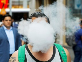 A man uses a vape as he walks on Broadway in New York City, U.S., September 9, 2019. "According to the U.S. Centers for Disease Control and Prevention (CDC), there are currently six deaths and 380 confirmed or probable cases of severe lung disease due to vaping," Christopher Labos writes.