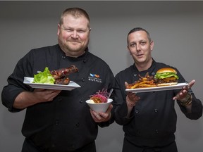 Western Fair District executive chef Michael Moore, left, and sous chef Kevin Waugh present three items available during the annual fair: smoked turkey wings, candy apple fritter on French vanilla ice cream and Ontario grass-fed beef burger with a side of root vegetable fries. (Derek Ruttan/The London Free Press)