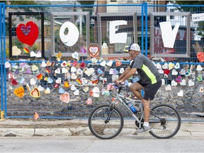 Mike Hancock rides his bike along explosion-ravaged Woodman Avenue Monday, Sept. 2, to reminisce about the good times he had at one of the homes damaged by the Aug. 14 car crash and explosion. Hancock's best friend used to live at 454 Woodman Ave. many years ago. "We had some great parties at the place," he said. "It was a happening spot." (Derek Ruttan/The London Free Press)