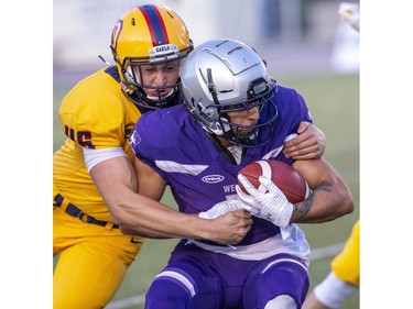 Peter Adjey of the Queen's Golden Gaels tackles Western Mustang  ball carrier Cole Majoros n the first quarter of the Mustang's home opener at TD Stadium in London, Ont. on Monday September 2, 2019. Derek Ruttan/The London Free Press/Postmedia Network