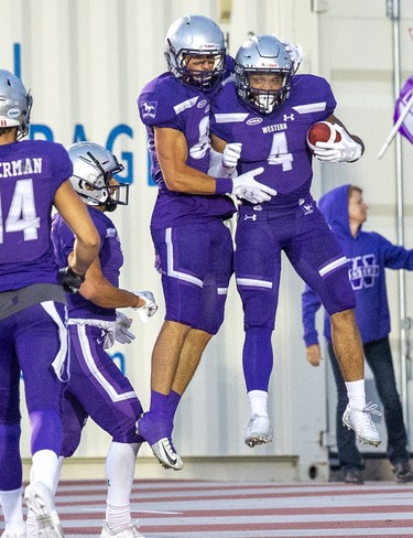 Trey Humes (right) celebrates his  touchdown with Malik Besseghieur during the first quarter of their game against the Queen's Golden Gaels at TD Stadium in London, Ont. on Monday September 2, 2019. Derek Ruttan/The London Free Press/Postmedia Network