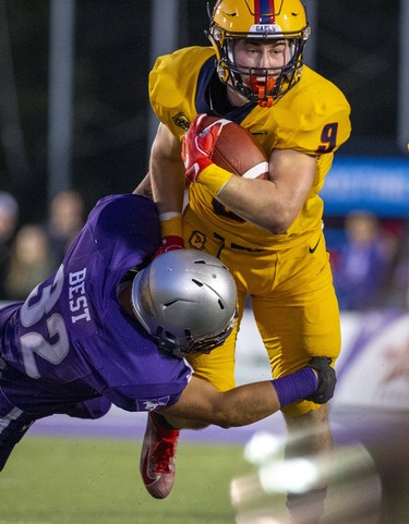 Ethan Martin of the Queen's Golden Gaels tis tackled by  Derek Best of the  Western Mustangs during the first quarter of the Mustang's home opener at TD Stadium in London, Ont. on Monday September 2, 2019. Derek Ruttan/The London Free Press/Postmedia Network