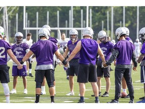 Western Mustang players take part in a post-practice ritual at TD Stadium in London, Ont. on Friday September 6, 2019. (Derek Ruttan/The London Free Press)